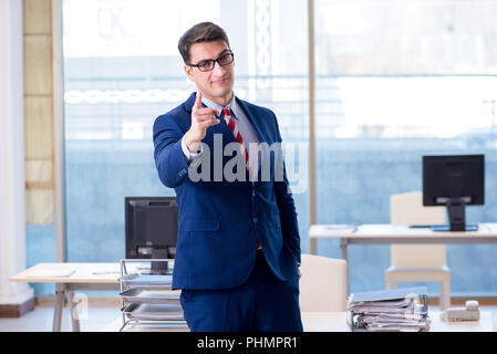 Young handsome businessman employee working in office at desk Stock Photo