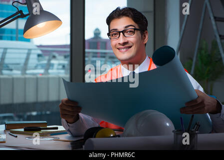 Construction architect working on drawings late at night Stock Photo