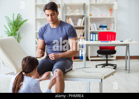 Doctor checking patients joint flexibility with gonimeter Stock Photo