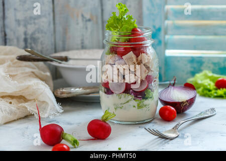 Salad with chicken and fresh vegetables in jar. Stock Photo