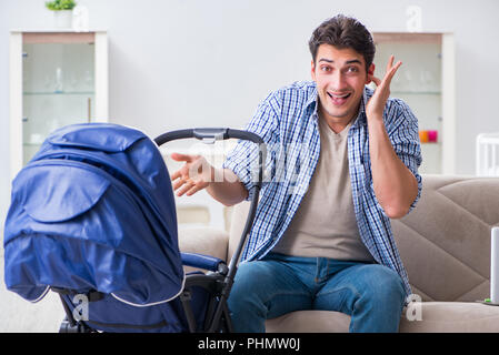 Young father looking after newborn baby at home Stock Photo