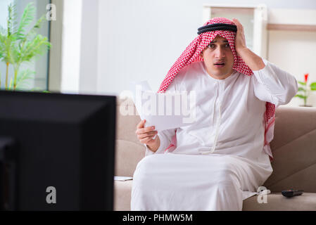 Arab businessman watching tv at home Stock Photo