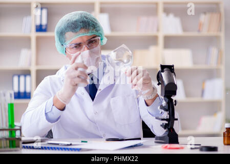 Forensics investigator working in lab on crime evidence Stock Photo