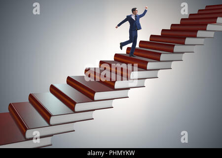 Businessman student climbing the ladder of education books Stock Photo