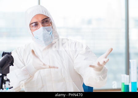 Young chemist student working in lab on chemicals Stock Photo