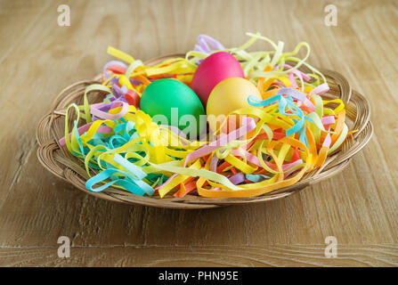 multi colored easter eggs in a basket Stock Photo