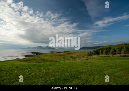 Looking towards the Isle of Rum, from the Isle of Muck.  Run and Muck are small islands in the Inner Hebrides of Scotland. Stock Photo