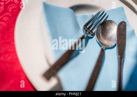 Fork, knife and spoon on a plate Stock Photo