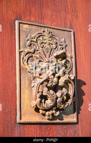 close-up of Rusty Antique door knocker on wooden door Stock Photo