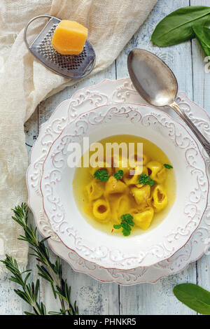 Tortellini in broth. Traditional Italian cuisine. Stock Photo