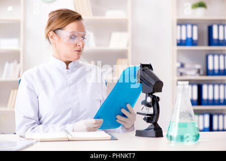 Woman chemist working in hospital clinic lab Stock Photo