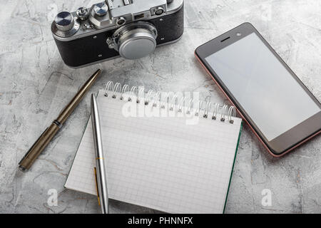 Notebook with film camera. Stock Photo