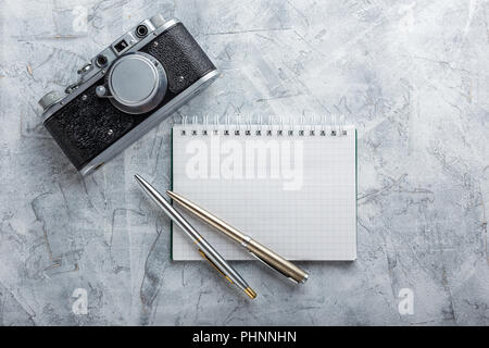 Notebook with film camera. Stock Photo