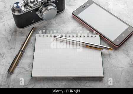 Notebook with film camera. Stock Photo