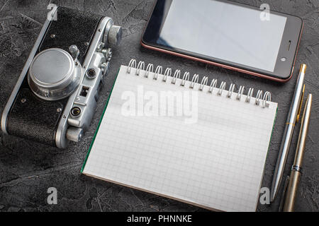 Notebook with film camera. Stock Photo