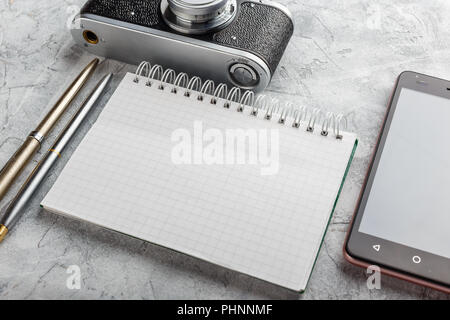 Notebook with film camera. Stock Photo