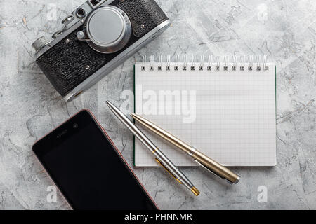 Notebook with film camera. Stock Photo