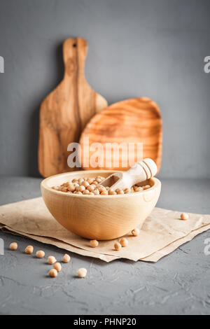 Chickpeas in a wooden bowl on gray background Stock Photo