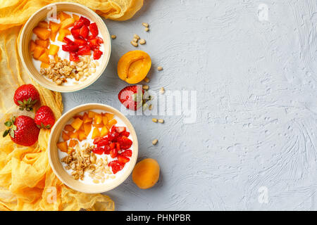 Homemade yogurt with granola, apricot and pine nuts Stock Photo