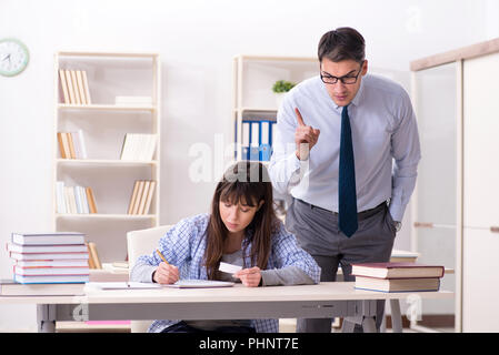 Male lecturer giving lecture to female student Stock Photo