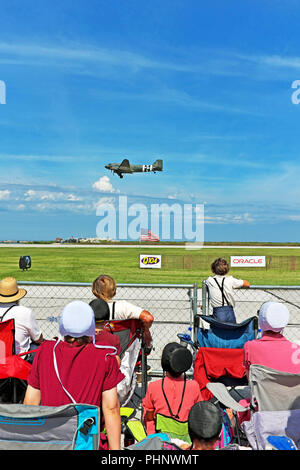 Cleveland, Ohio, USA, 1st Sept, 2018.  Amish spectators watch as a plane passes over a US flag at the 54th Annual Cleveland National Air Show at Burke Lakefront Airport in Cleveland, Ohio, USA.  Credit: Mark Kanning/Alamy Live News. Stock Photo