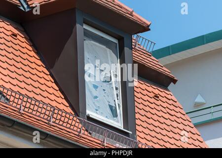 Broken fly screen on a roof window Stock Photo