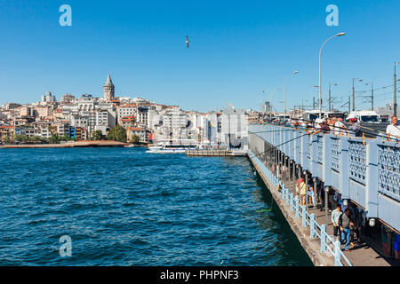 Istanbul, Turkey - August 14, 2018: Men catch fish from the Galata Bridge on August 14, 2018 in Istanbul, Turkey. Stock Photo