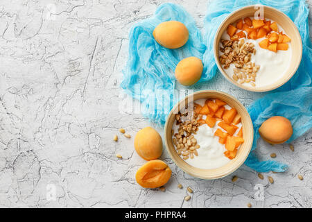 Homemade yogurt with granola, apricot and pine nuts Stock Photo