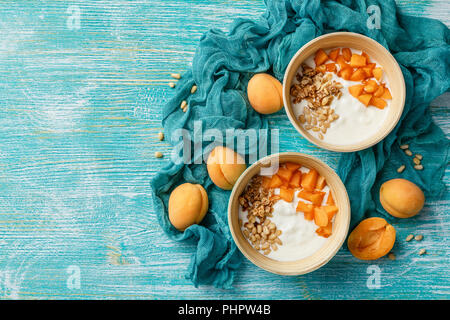 Homemade yogurt with granola, apricot and pine nuts Stock Photo