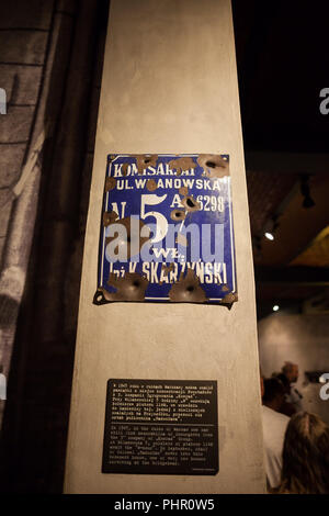 Bullet holes on street plate from fights at 1944 Uprising in Warsaw Rising Museum in Warsaw, Poland Stock Photo