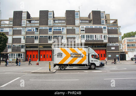 A London Evening Standard delivery van passing in front of Shoreditch Fire Station, Old Street, Hoxton, London, EC1, UK Stock Photo