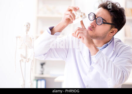 Crazy doctor studying human skeleton Stock Photo