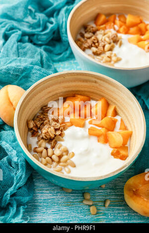 Homemade yogurt with granola, apricot and pine nuts Stock Photo