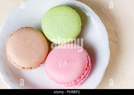 Colourful macaroons on the plates Stock Photo