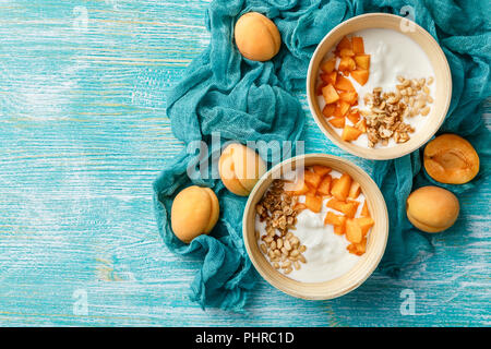 Homemade yogurt with granola, apricot and pine nuts Stock Photo