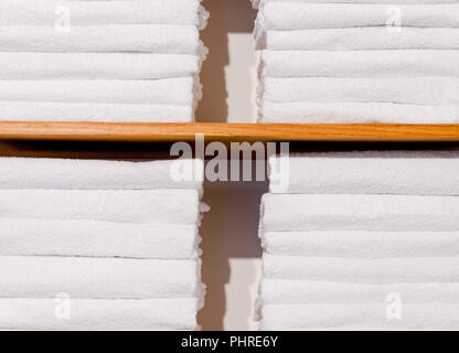bright towels folded in shelf. Close-up Stock Photo