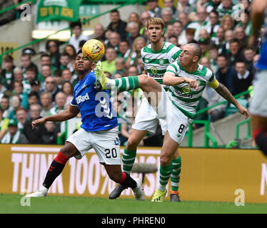 Rangers Alfredo Morelos (left) and Celtic’s Scott Brown battle for the ball during the Ladbrokes Scottish Premiership match at Celtic Park, Glasgow. Stock Photo