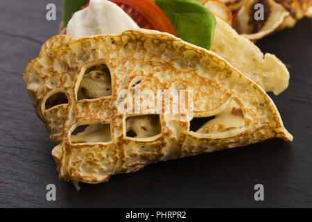 Pancakes sutffed with ham, cheese, tomatoes and spinach Stock Photo