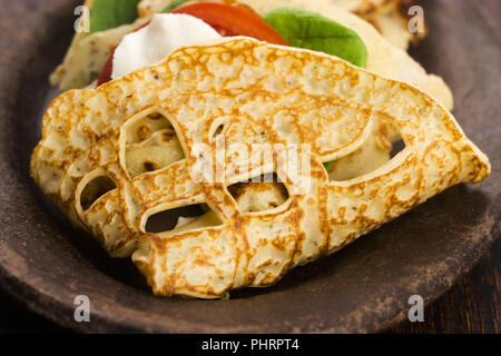 Pancakes sutffed with ham, cheese, tomatoes and spinach Stock Photo