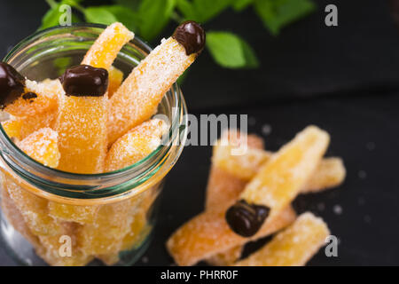 Orange slices in dark chocolate, close-up Stock Photo