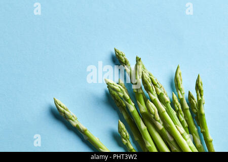 Close up of fresh asparagus on blue background Stock Photo