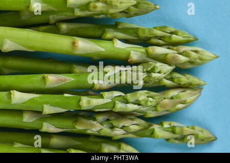 Fresh green asparagus for cooking on blue background Stock Photo