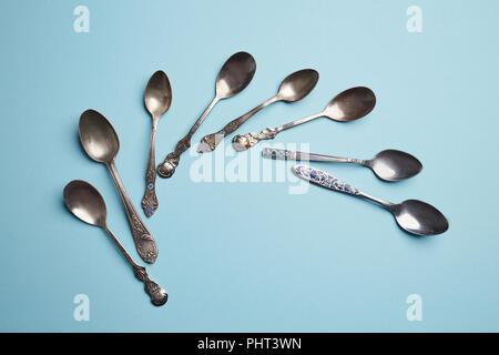 Metal tea spoon isolated on blue with copy space Stock Photo