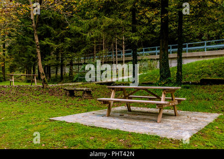 wooden benches and tables for picnics in the mountain landscape in autumn Stock Photo