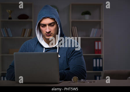 Hacker hacking the data late at night Stock Photo