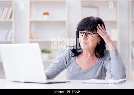 Senior woman struggling at computer Stock Photo