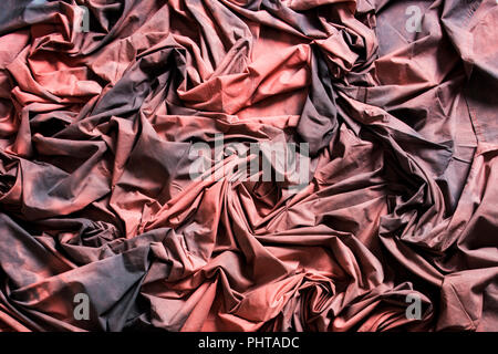 Red Black Cotton Textured Cloth Folded With Deep Shadows Stock Photo