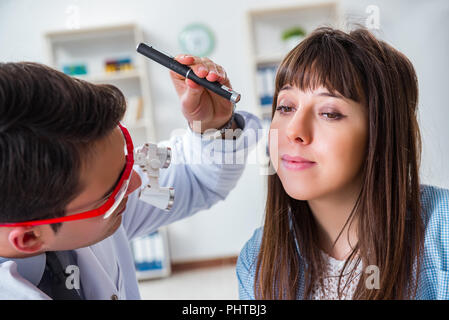 Doctor examining patients eye in hospital Stock Photo