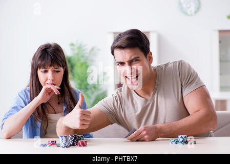 Young family playing cards at home Stock Photo