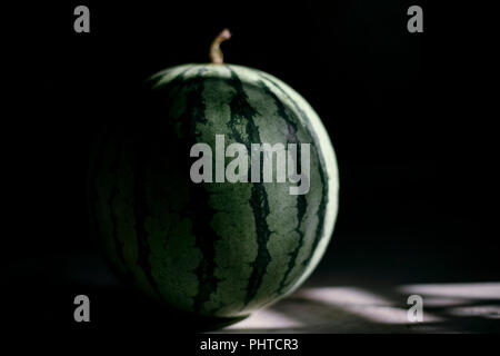 A close up macro photo of a watermelon on a dark background Stock Photo
